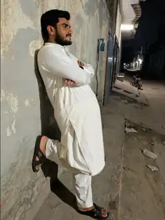 man leaning against wall at night