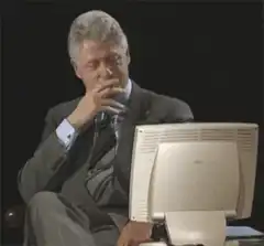 Bill Clinton smoking in front of computer