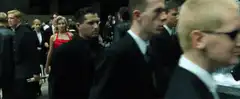Red dress woman walks past crowd
