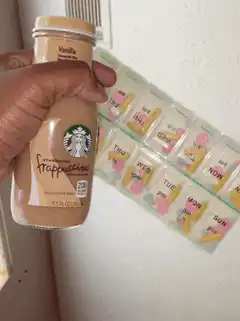 Starbucks Frappuccino next to pill organizer