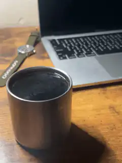 coffee cup on desk with laptop