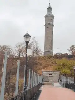 stone tower on hill with walkway