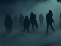 Silhouettes of people walking in fog