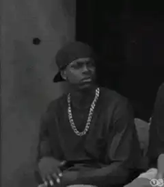Man in chain nodding and looking around