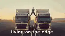 Man balancing on truck mirrors