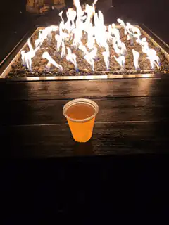 beer cup in front of fire pit