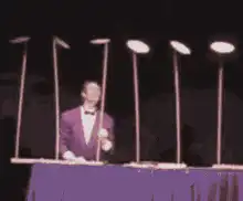 Man juggling six golf clubs