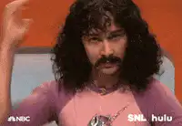 Man with mustache holding paper flowers