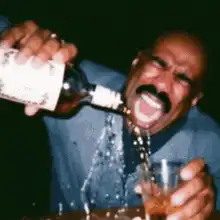Steve Harvey pouring a drink