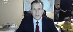 BBC News anchor with kids in background