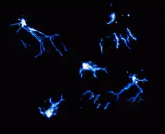 Blue lightning bolts on black background