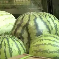 Man with watermelon face paint