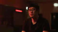 Man with glasses in red light