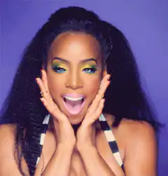 Woman with green eyeshadow poses excitedly