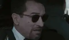 Robert De Niro as Travis Bickle aiming gun