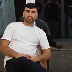 Man in white t-shirt sitting on chair
