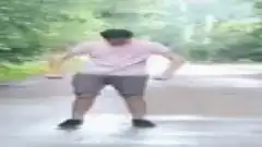Man dancing on wet road