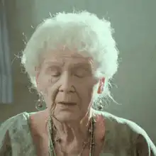 Elderly woman shaking head no