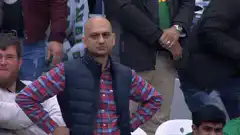 Bald man in vest looks around
