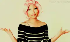 Nicki Minaj shrugging and smiling