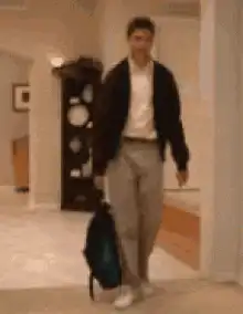 Man drops bag and collapses on floor