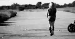 woman walking away from motorcycle