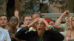 Bald man screams with crowd
