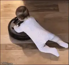 Baby riding a Roomba
