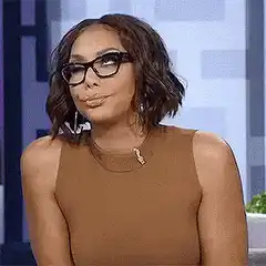Jasmine Guy smirking and nodding