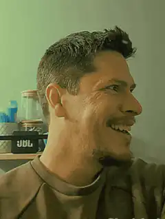 Man's smile turns into a wide-eyed laugh