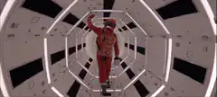 Astronaut walking down a futuristic corridor
