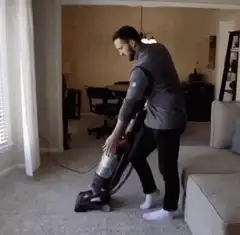 Man dancing with vacuum cleaner