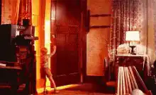 Young boy opens door to bright light