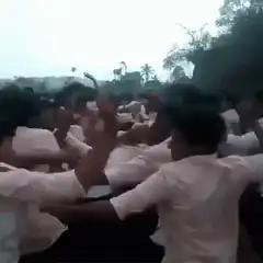 crowd of men in white shirts dancing