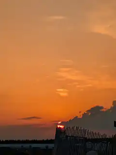 sunset behind fence