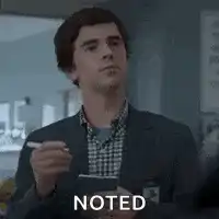 Noted man writing in notebook