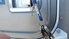 Hand opens truck door to reveal cat