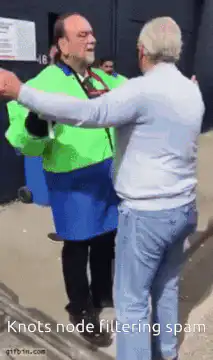 Man in green and blue jacket filtering people