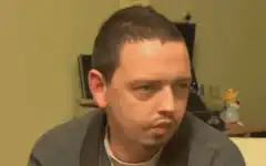 Man with a mustache looking skeptical
