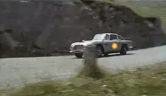 James Bond car with Bitcoin logo driving