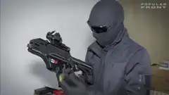 Person with futuristic gun says I am extremely peaceful