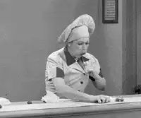 Chef rolls dough on counter