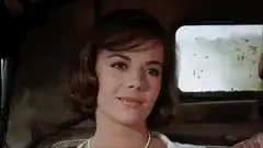 Natalie Wood smiling in a car