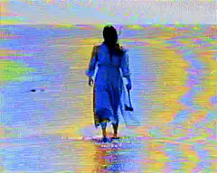 Woman walking on beach with axe