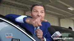 Man in blue suit pointing finger