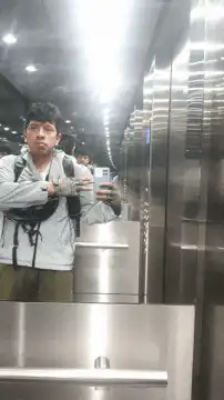 Man in elevator checking watch