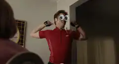 Man in red shirt flexing with googly eyes