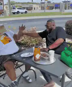 Man falls off chair while eating