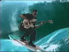 Surfer playing bass guitar on a wave