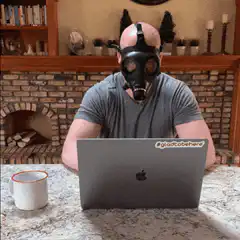 man in gas mask drinking coffee
